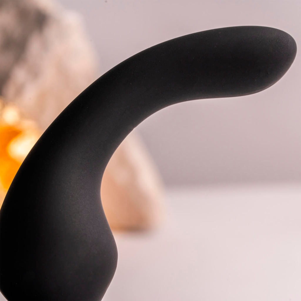 Black silicone curved plug with smooth surface and flared tip