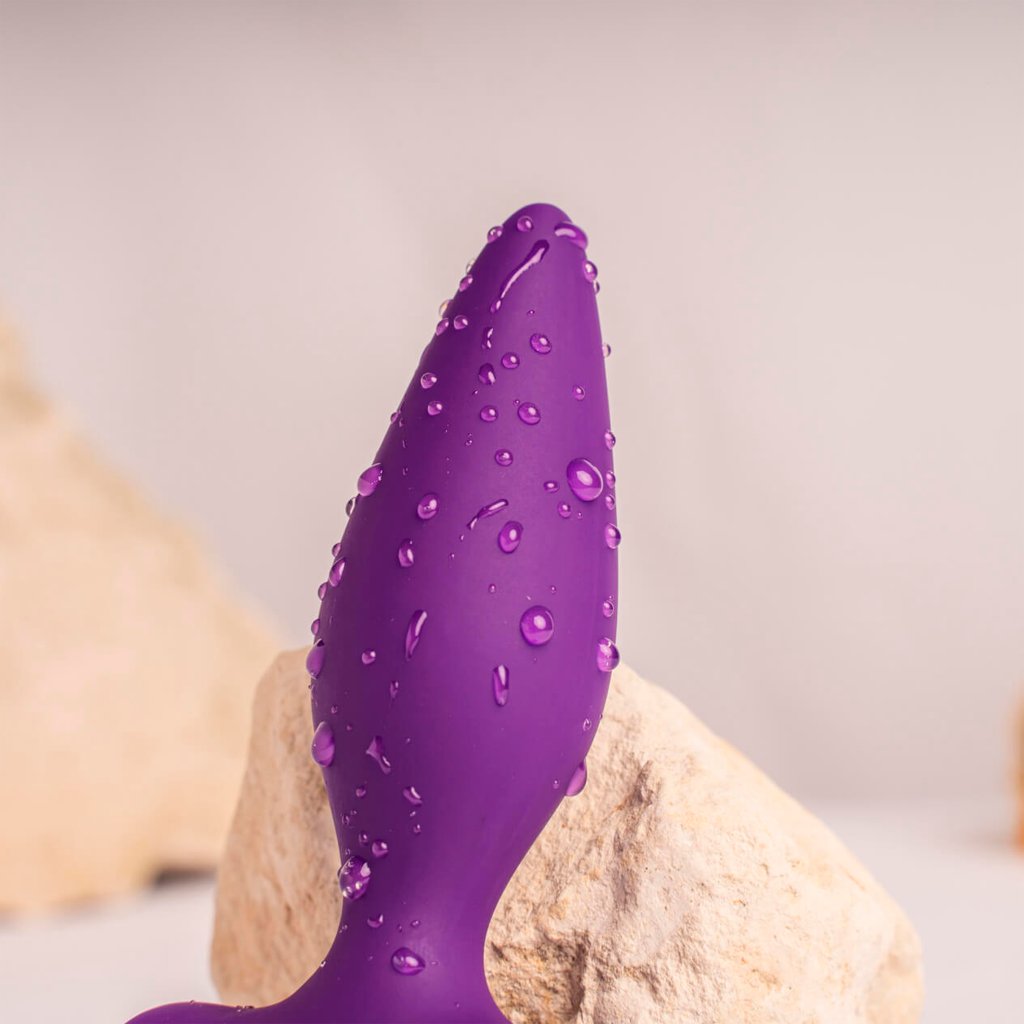 Purple silicone anal plug with raised stud pattern and narrow tapered tip