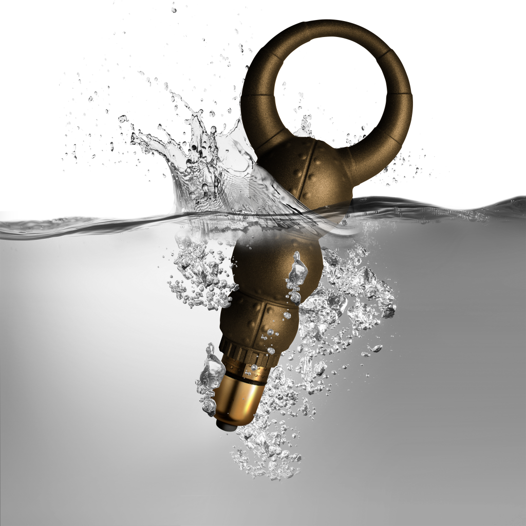 Gold-toned handheld massager with loop handle and rounded bulb shape