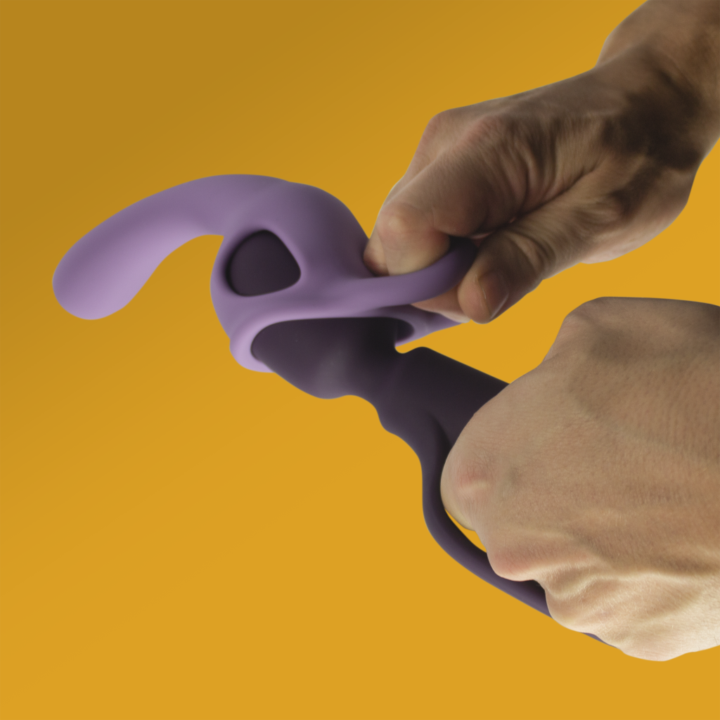 Purple silicone massager attachment with black end, held by hands