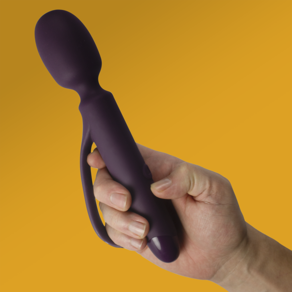 Purple silicone wand massager with curved handle and rounded tip, held upright