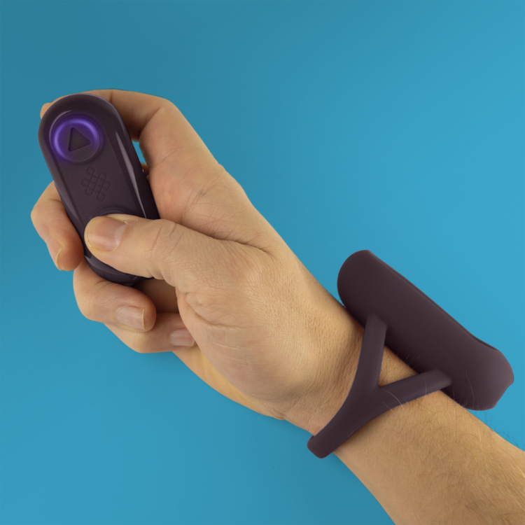 Purple silicone massager controller with button icons, held in hand
