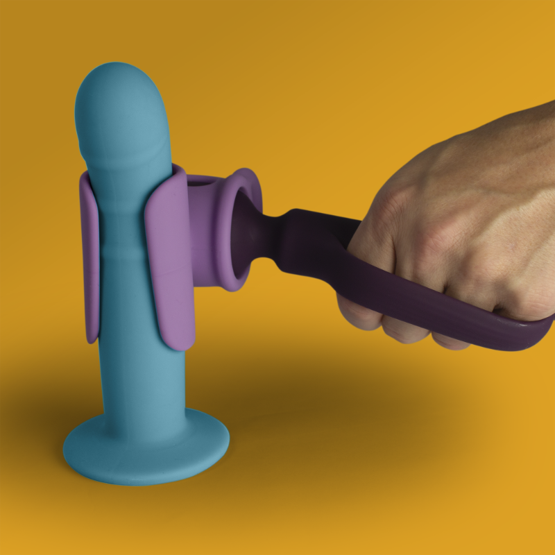 Light blue standing massager base with purple wand attachment, held by hand