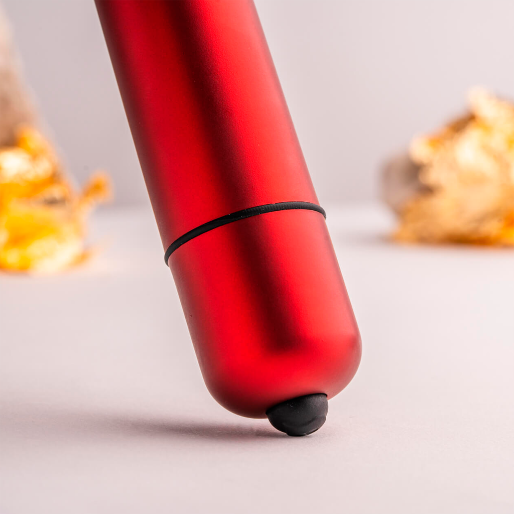 Red lipstick bullet with black band and rounded base