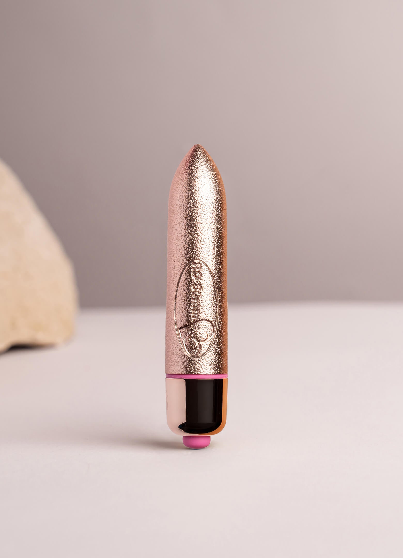 Small bullet vibrator in rose gold glitter effect.