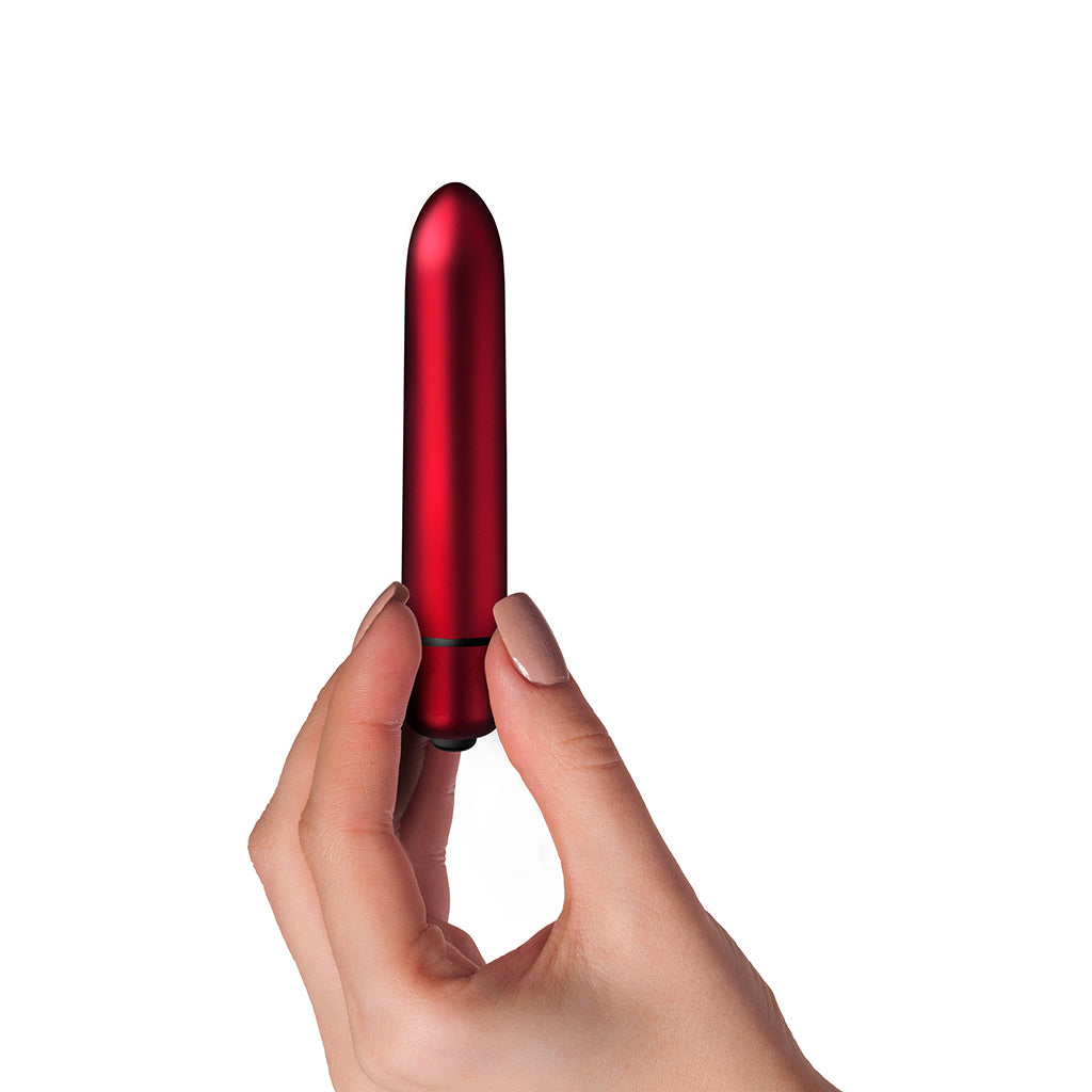 Scarlet Velvet bullet vibrator, product shown held in to show relative size.
