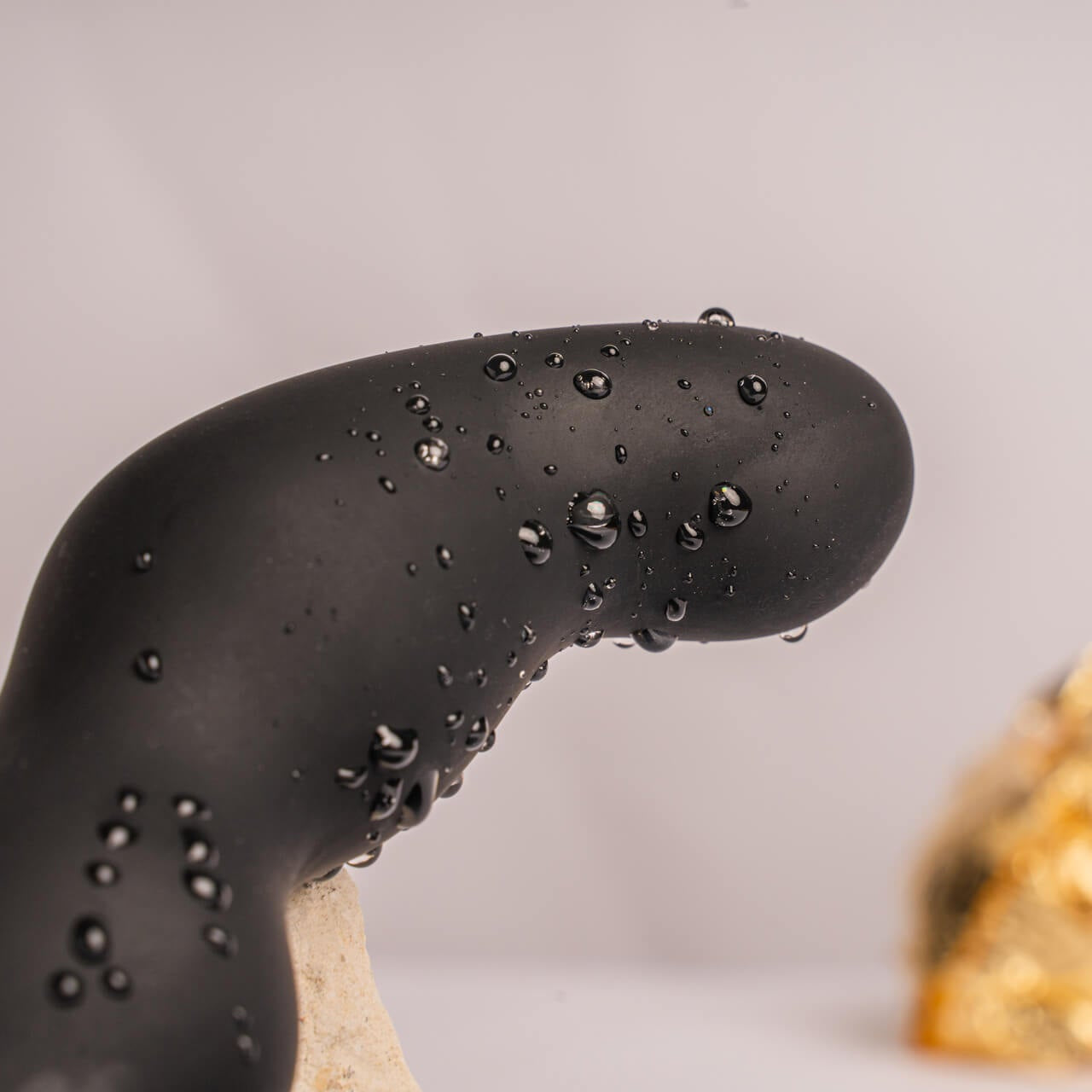 Close up of the end of the Bad Boy prostate toy. beaded with water showing that it is waterproof