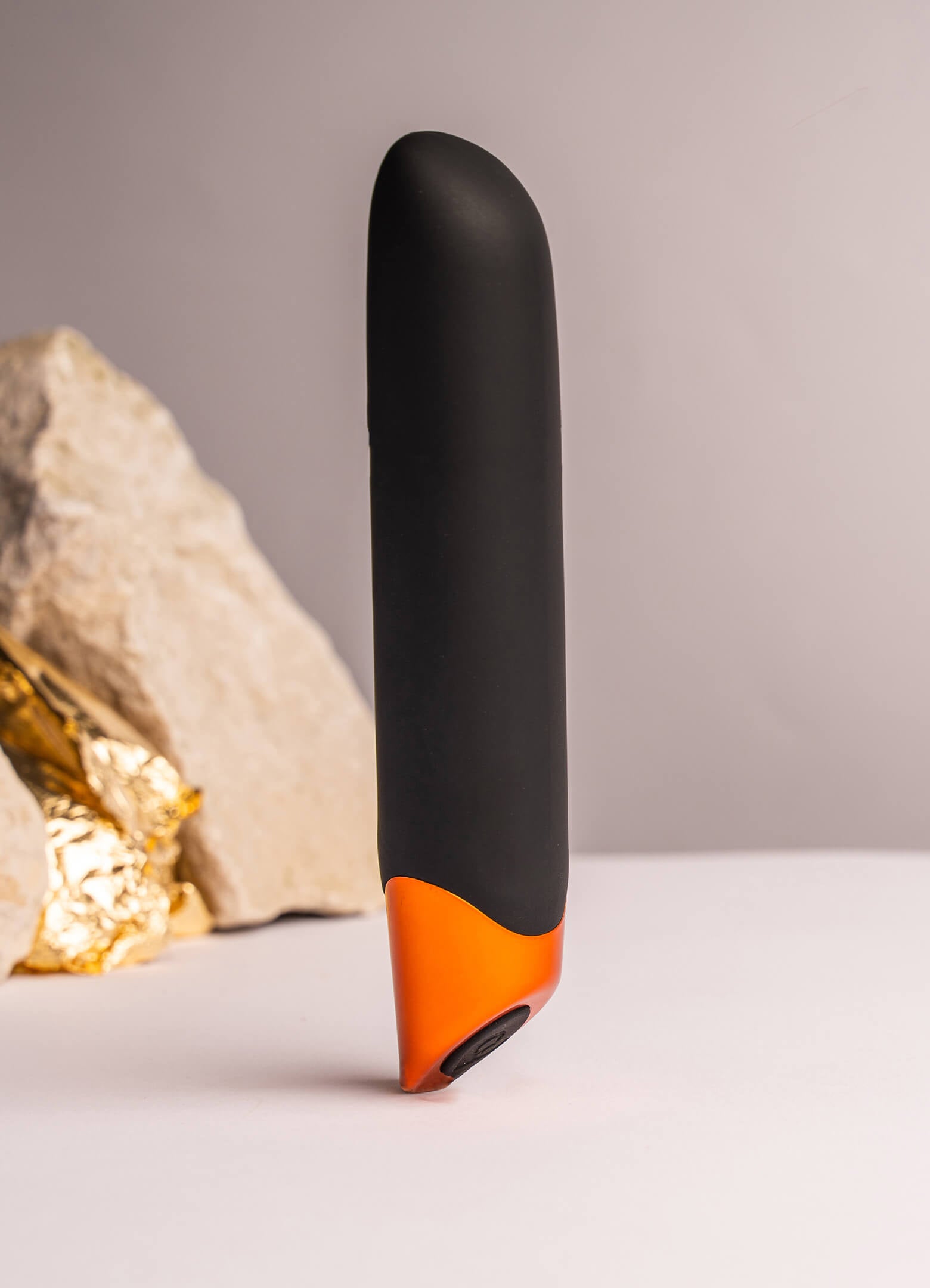 Elegant black and copper vibrator with a chiseled tip.