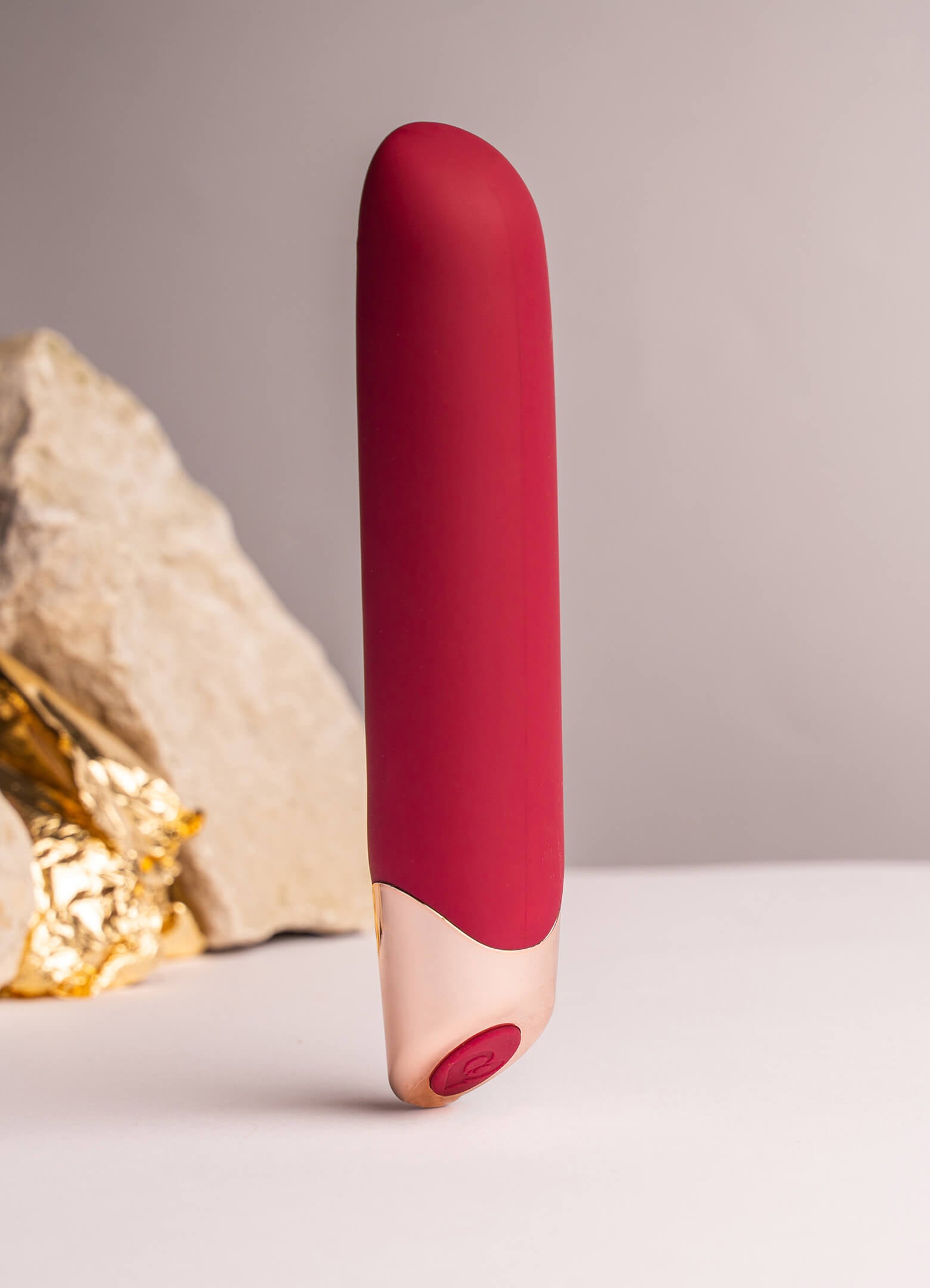Burgundy and rose gold elegant vibrator with a chiseled tip.