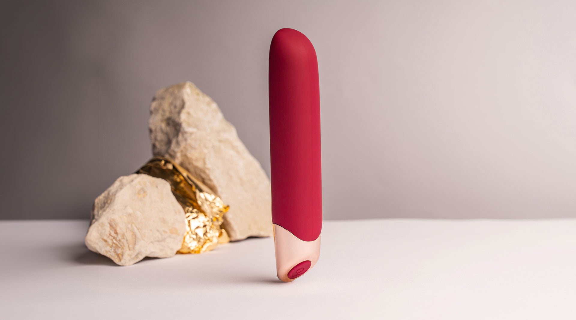 Burgundy and rose gold elegant vibrator with a chiseled tip.