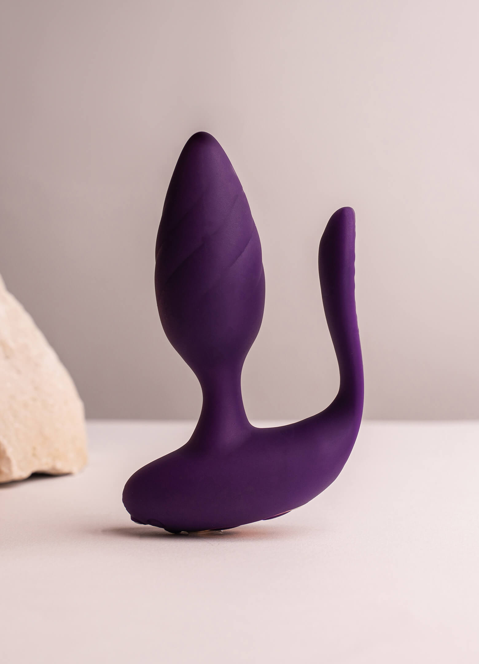 Purple silicone butt plug with an insertable vaginal tail.
