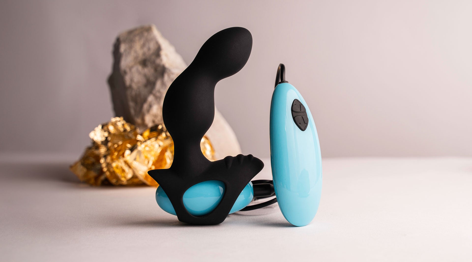 Remote controlled prostate vibrator in black and blue with a ribbed perineum pleasure point.