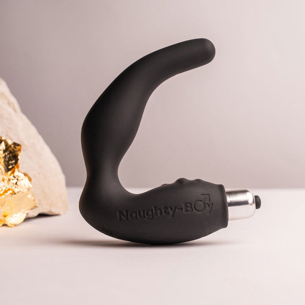 Silicone naughty-boy prostate massager with rippled perineum pleasure points housing a removable bullet vibrator in black.