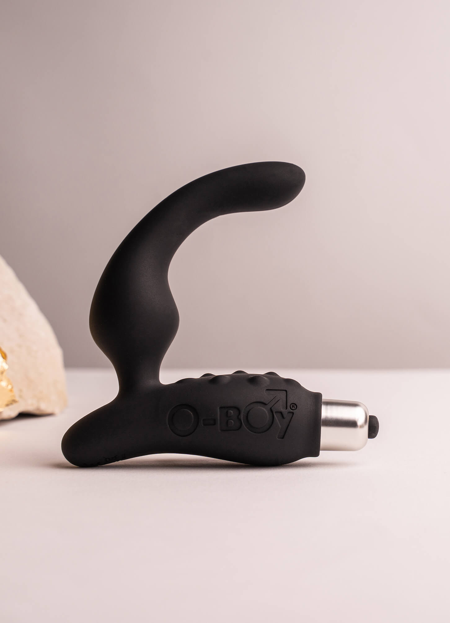 Silicone vibrating prostate massager with perineum pleasure points in black housing a removable bullet vibrator.
