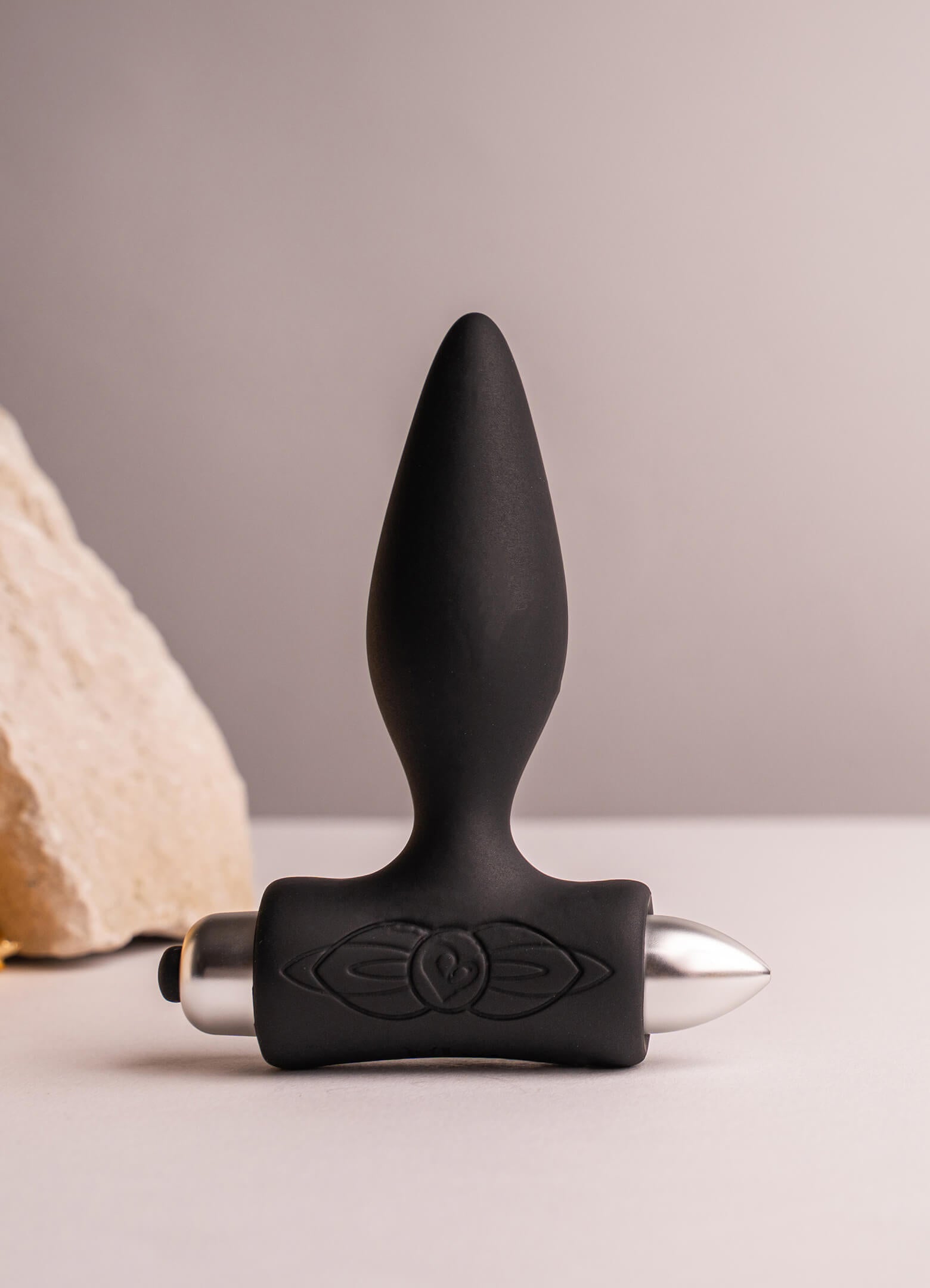 Black silicone tapered tip butt plug housing a removable bullet vibrator.