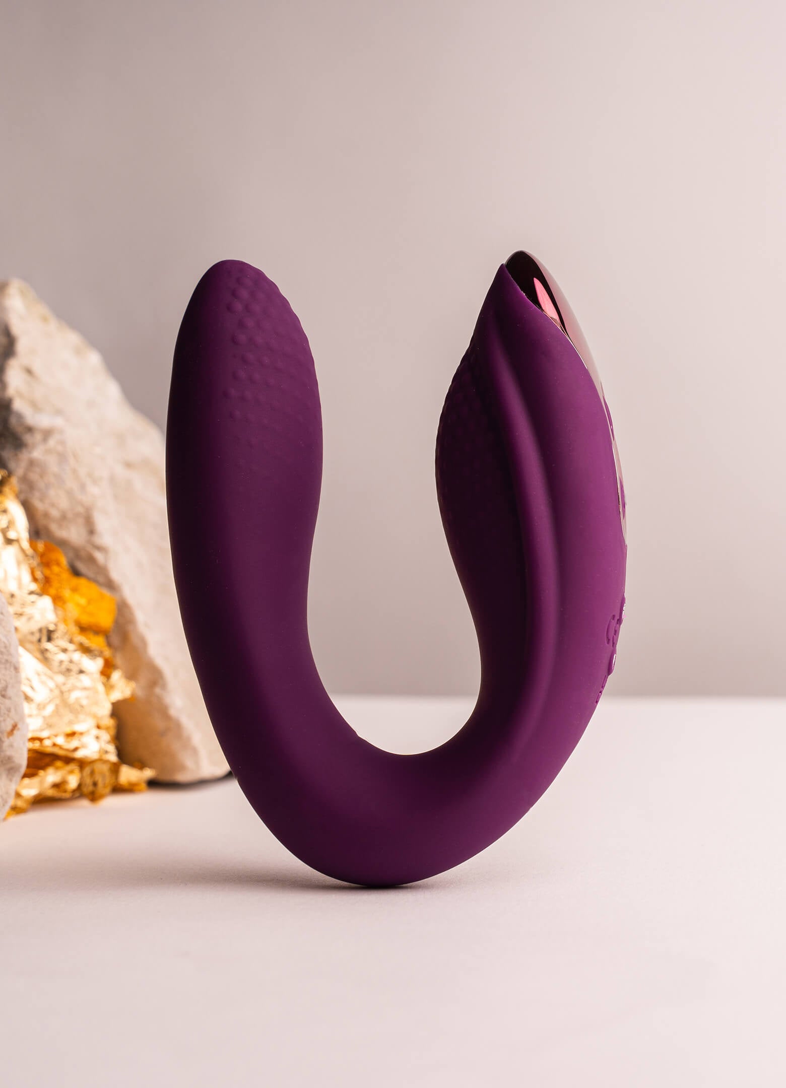 Burgundy silicone C-shaped internal and external vibrator.