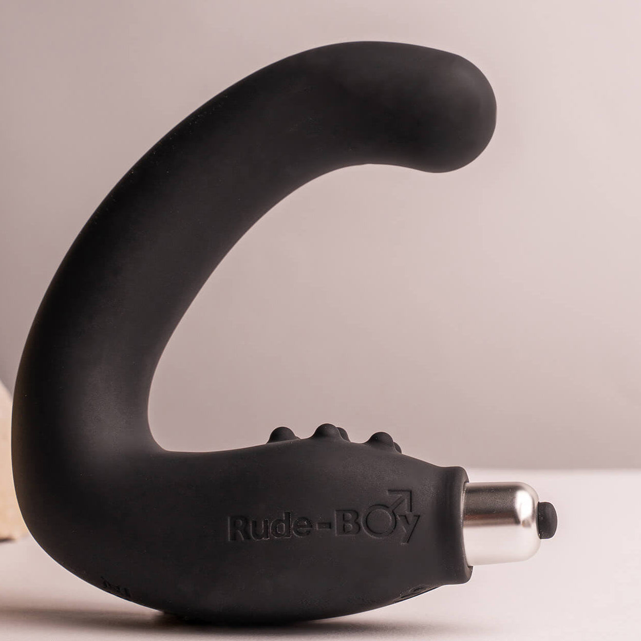Silicone rude boy prostate massager with perineum stimulation points in black housing a removable bullet vibrator.