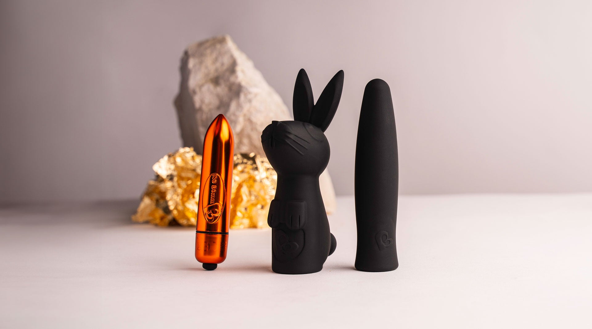 Orange bullet vibrator with a rabbit and finger sleeve set.