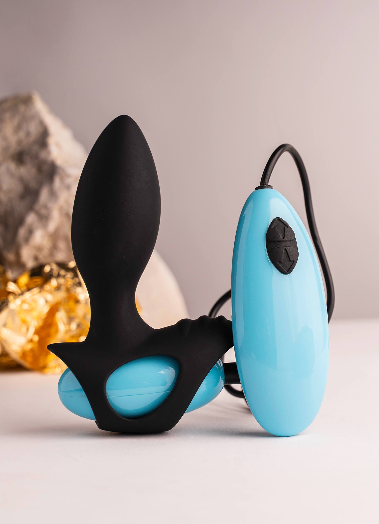 Black and blue remote controlled butt plug with perineum stimulation point.