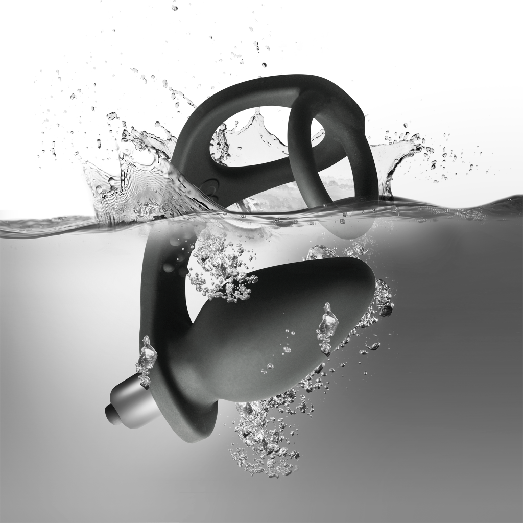 Black silicone pleasure device with loop ring and flared tip, shown in water splash