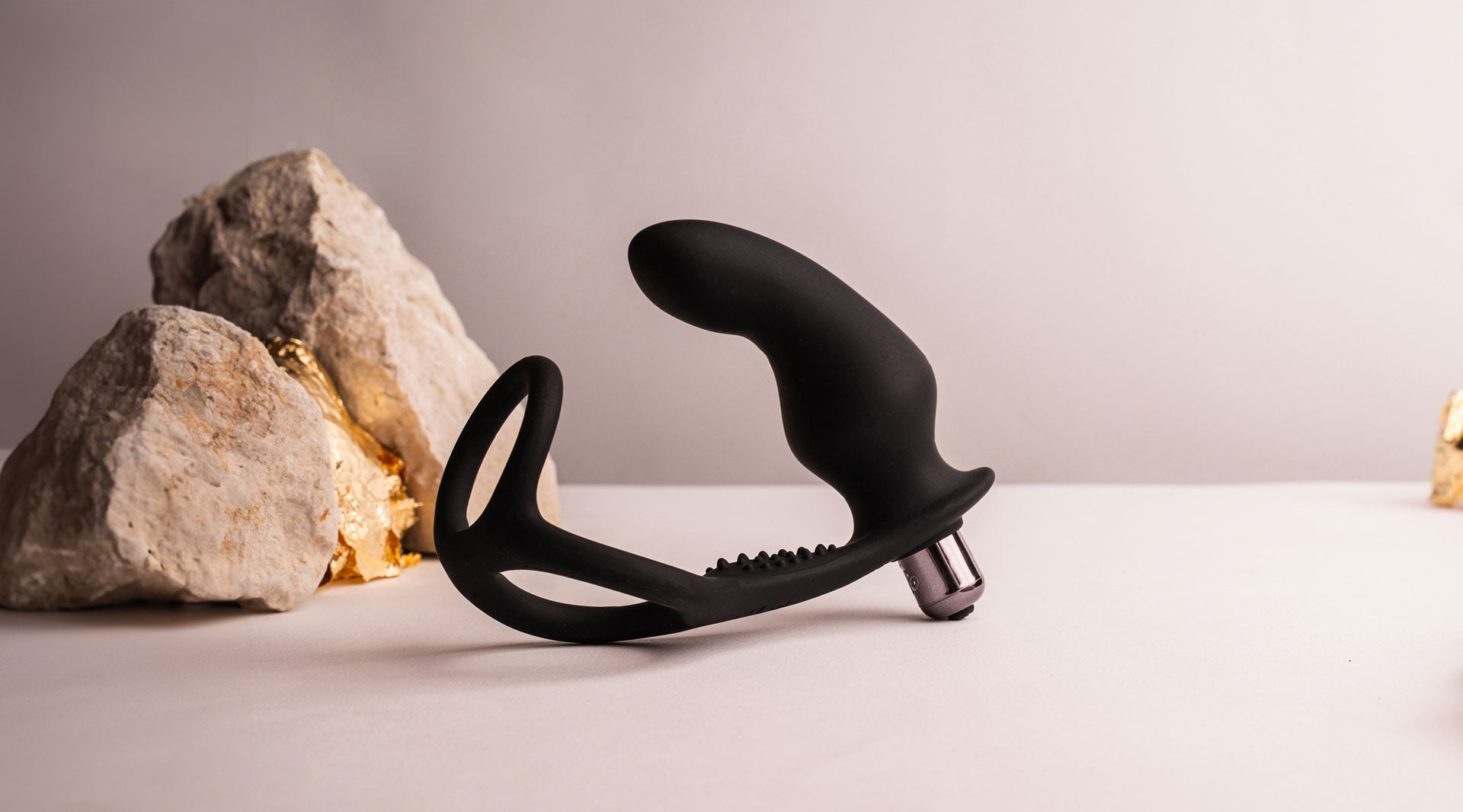Silicone black prostate massager with cock and ball ring in one housing a removable bullet vibrator.