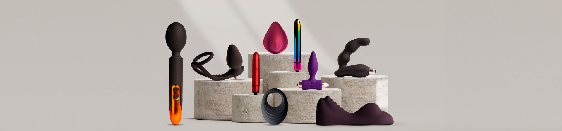 Collection of rocks-off products on a stone podium including vibrators and bullets