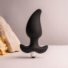 Rocks Off Butt Quiver - Black Butt Plug With Bullet Vibe - lifestyle shot with tactical rock