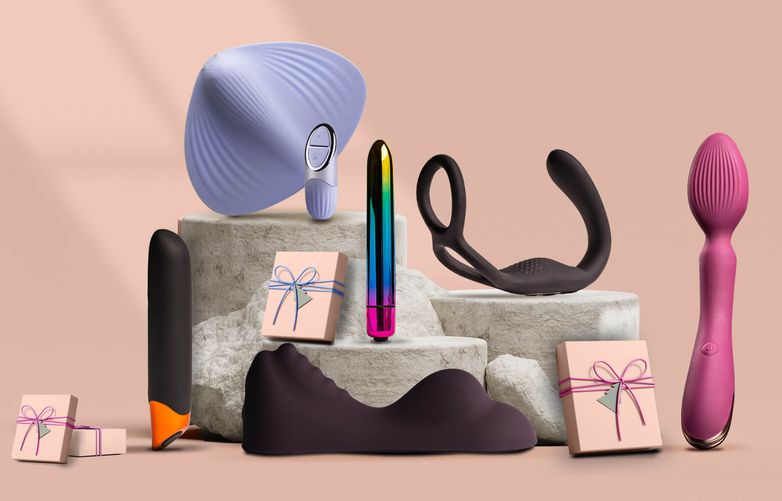 Collection of products including Sit on vibrators, Bullets and C-Rings on a grey podium surrounded by presents