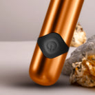 Havana orange metallic massager wand close-up of black control button