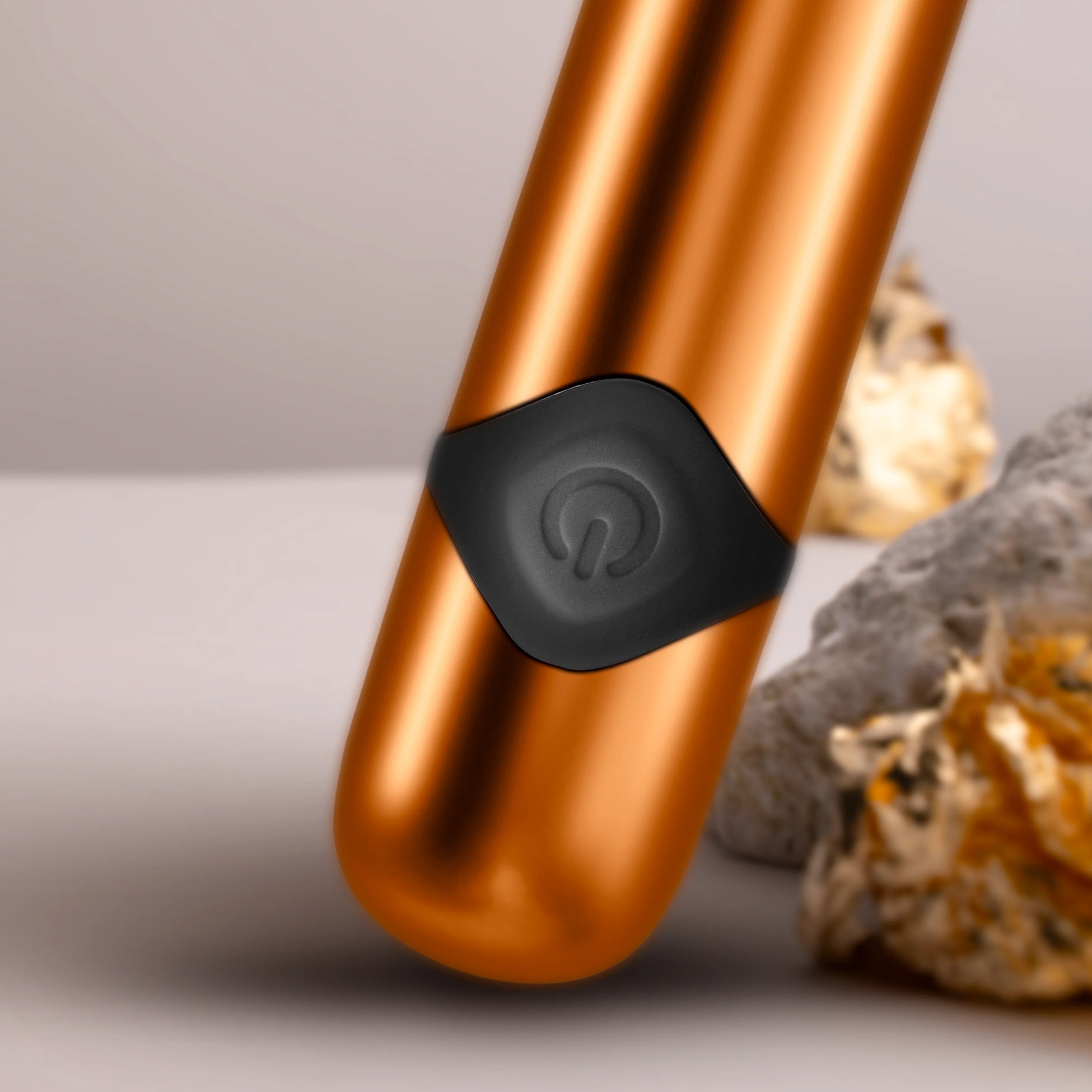 Havana orange metallic massager wand close-up of black control button