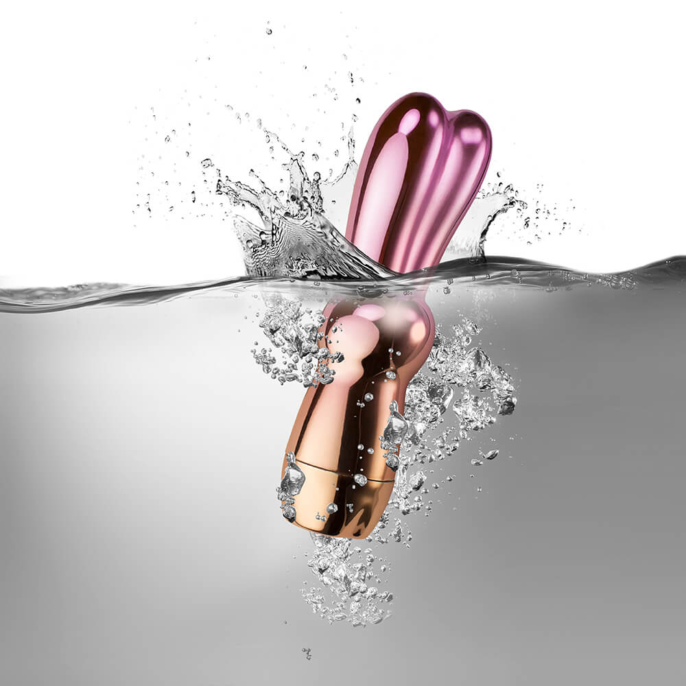 Little charm vibrator product half submerged in water 