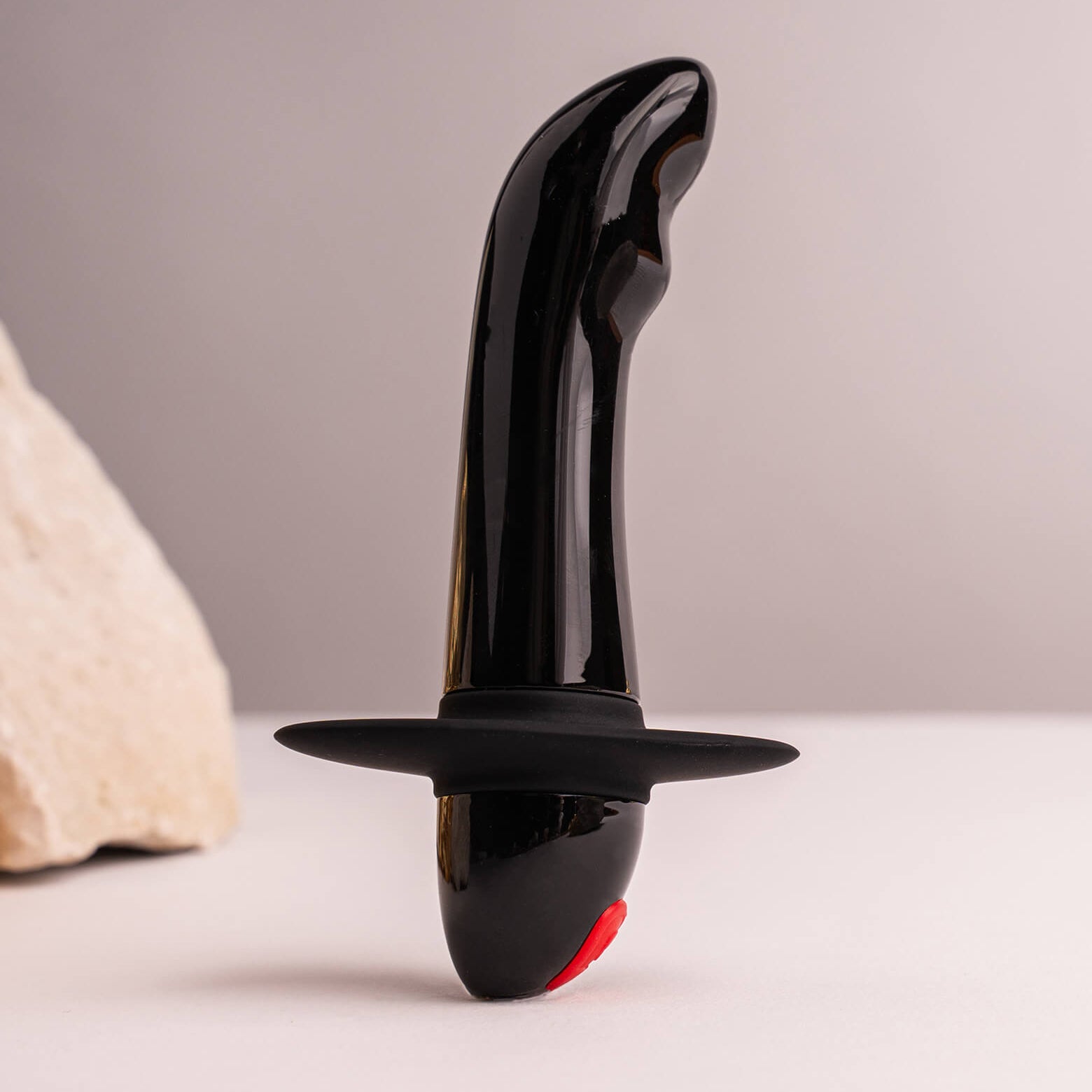Small black quest prostate vibrator with a safety flange.
