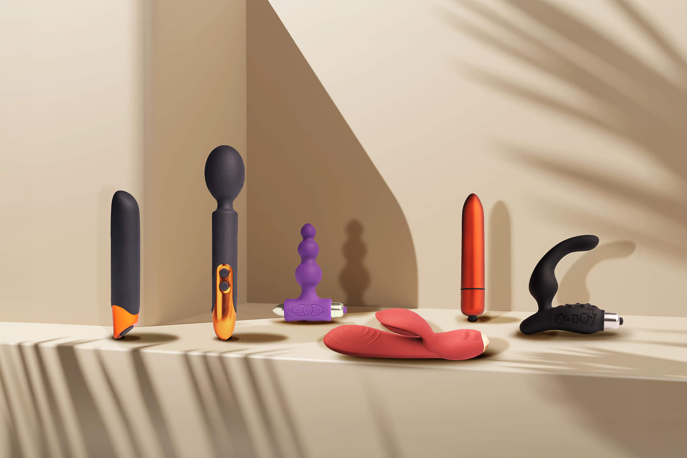 selection of rocks-off products set against a cream coloured background including rabbit vibrator, prostate massager, wand, bullet and anal toy