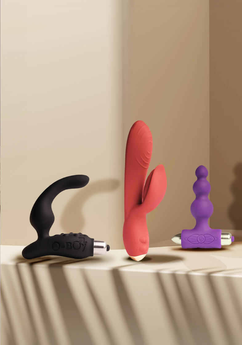 selection of rocks-off products set against a cream coloured background including rabbit vibrator, prostate massager and anal toy